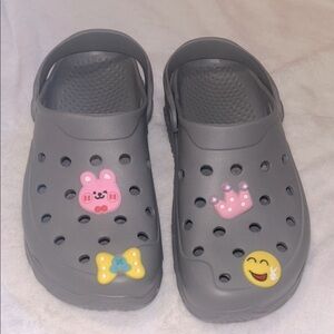 Grey Crocs clogs with Fun Jibbitz Charms